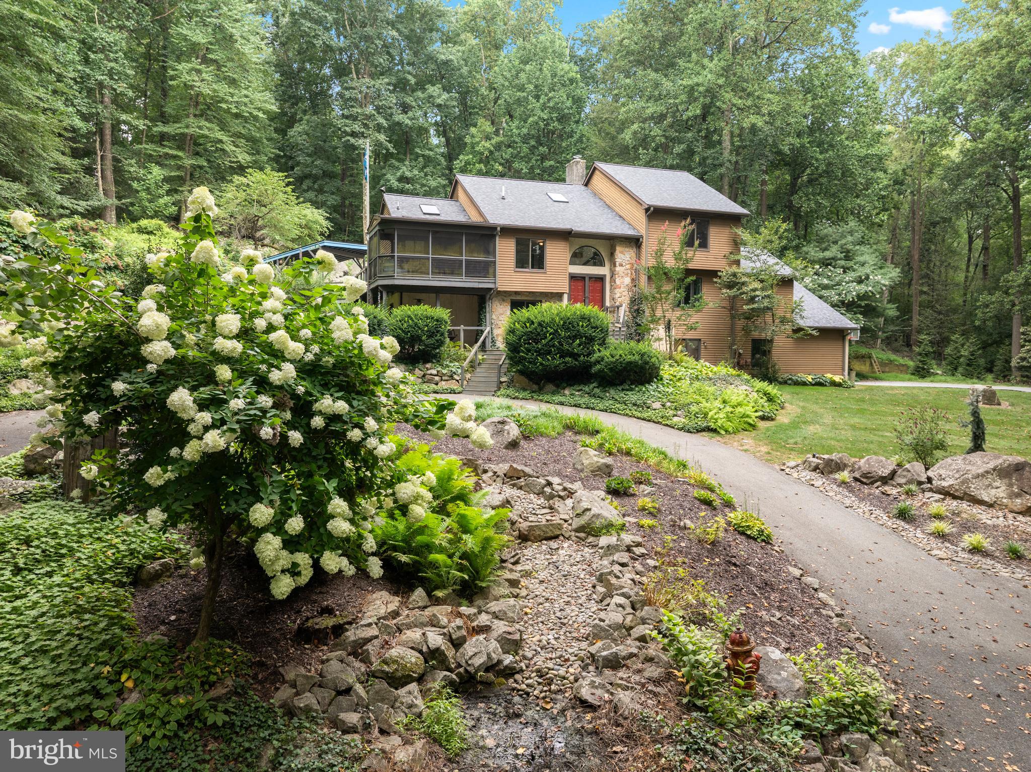 a front view of a house with a yard and shrubs