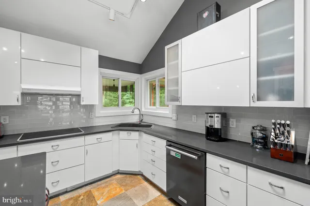 a kitchen with a sink stove and cabinets