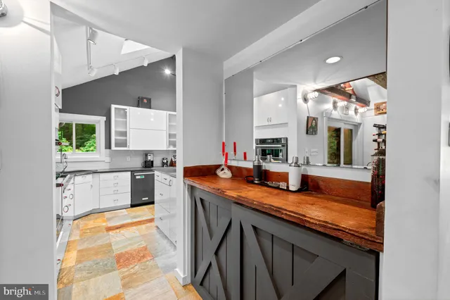 a kitchen with stainless steel appliances granite countertop a sink and cabinets