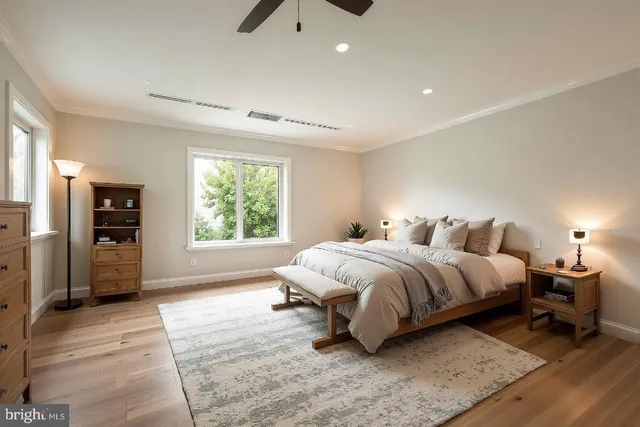a spacious bedroom with a bed and a window