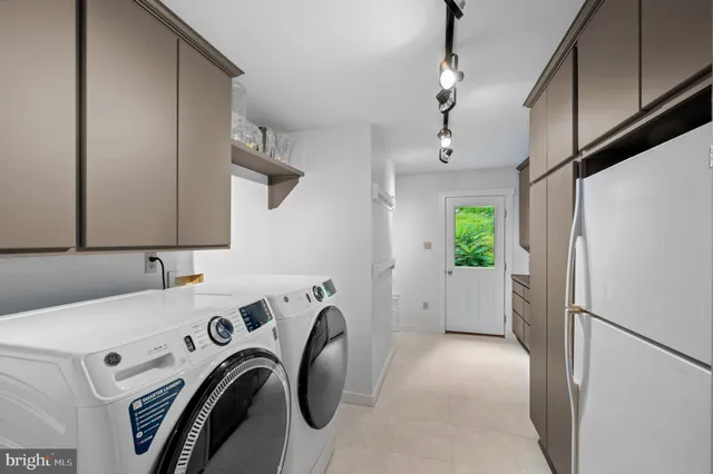 a view of storage and utility room with washer and dryer