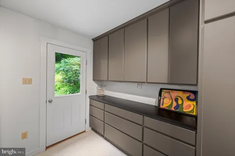 a view of storage and utility room with window