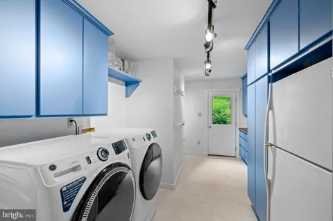 a view of storage and utility room with washer and dryer