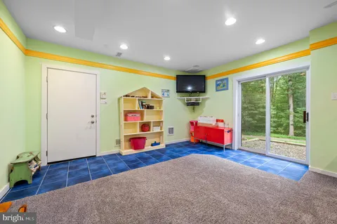 a living room with furniture and floor to ceiling window
