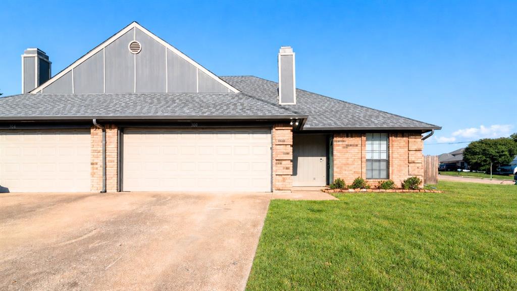 Brick and siding exterior featuring a gray shingle roof
