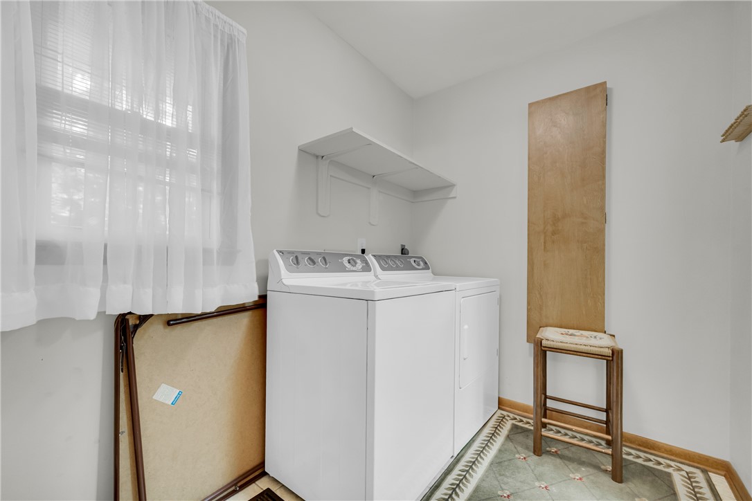 103 Colleton Court Clemson, SC 29631 - Photo 26 of 49 Functional laundry setup highlights tiled flooring and built-in shelving alongside natural light.