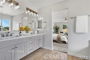 a spacious bathroom with a double vanity sink and a mirror