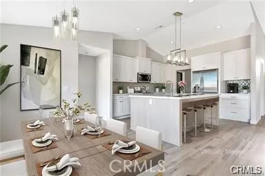 a kitchen with stainless steel appliances kitchen island granite countertop a stove and white cabinets