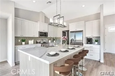 a view of kitchen with sink and refrigerator