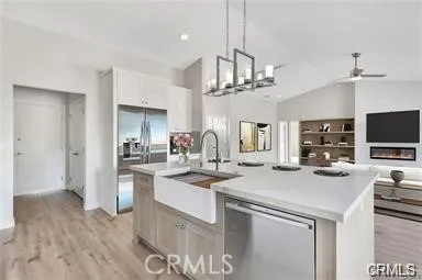 a kitchen with stainless steel appliances a sink and a refrigerator