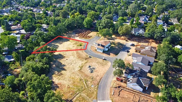 an aerial view of a house with a yard and swimming pool