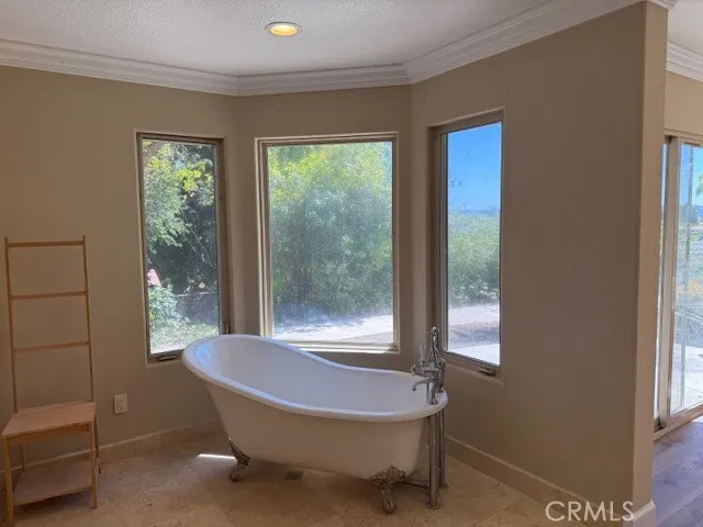 a room with a balcony a bed and a window