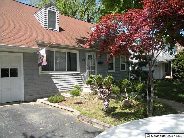 804 Allaire Road Spring Lake Heights, NJ 07762 - Photo 1 of 9 a front view of a house with garden