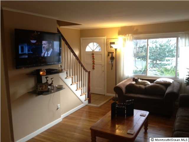 804 Allaire Road Spring Lake Heights, NJ 07762 - Photo 2 of 9 a living room with furniture and a flat screen tv