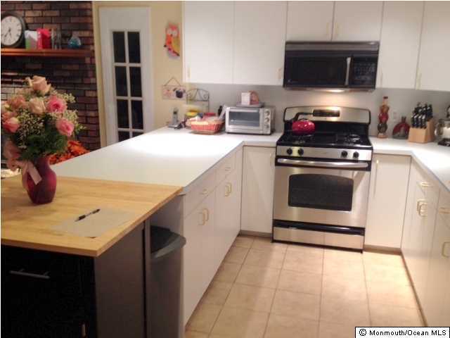 804 Allaire Road Spring Lake Heights, NJ 07762 - Photo 3 of 9 a kitchen with stainless steel appliances a stove microwave and cabinets