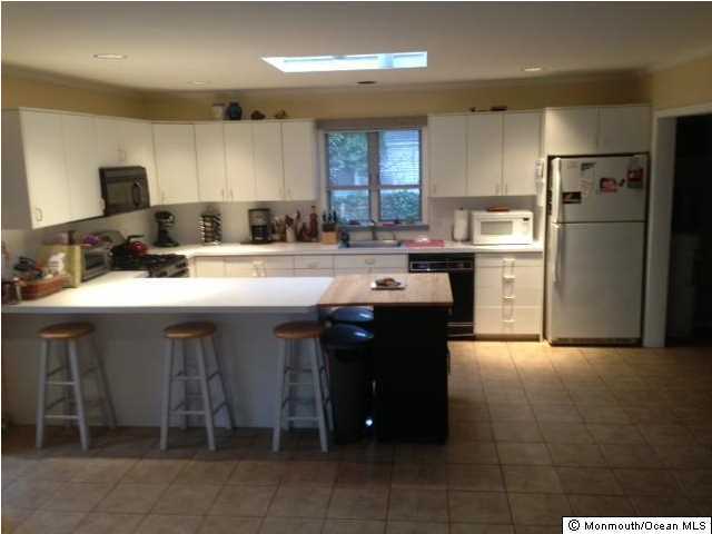 804 Allaire Road Spring Lake Heights, NJ 07762 - Photo 4 of 9 a kitchen with a sink a refrigerator and chairs