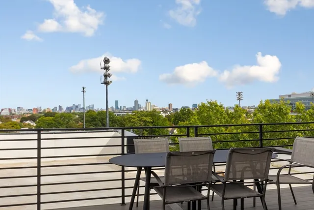 a view of a roof deck with furniture