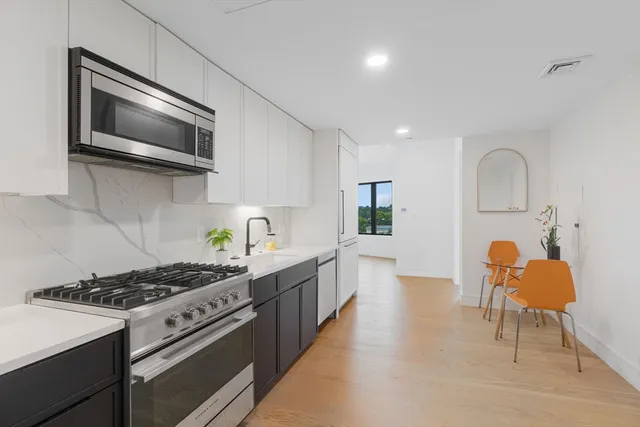 a kitchen with a refrigerator and a sink