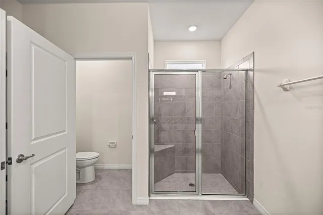 a bathroom with a shower and a toilet