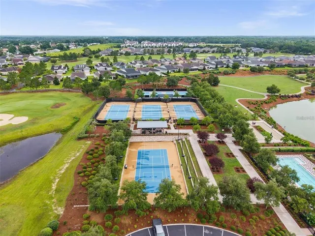 a view of a large building with a big yard and large trees