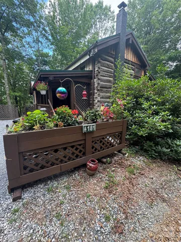 a view of backyard with deck and trees