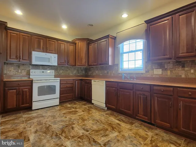 a view of kitchen with refrigerator and cabinet