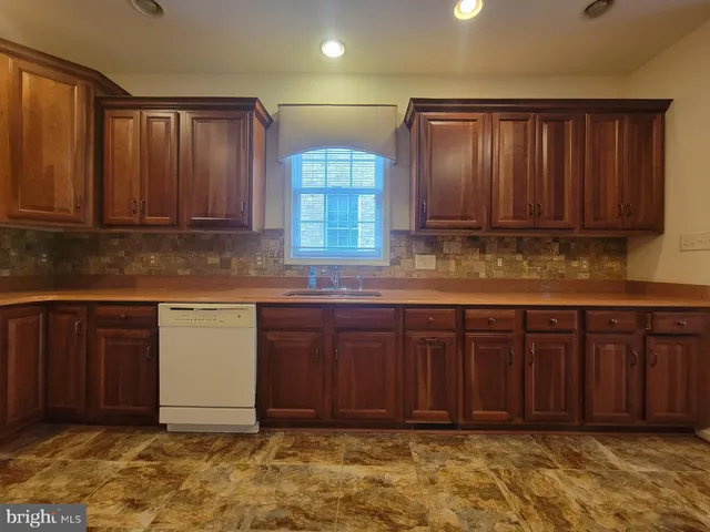 a kitchen with wooden cabinets