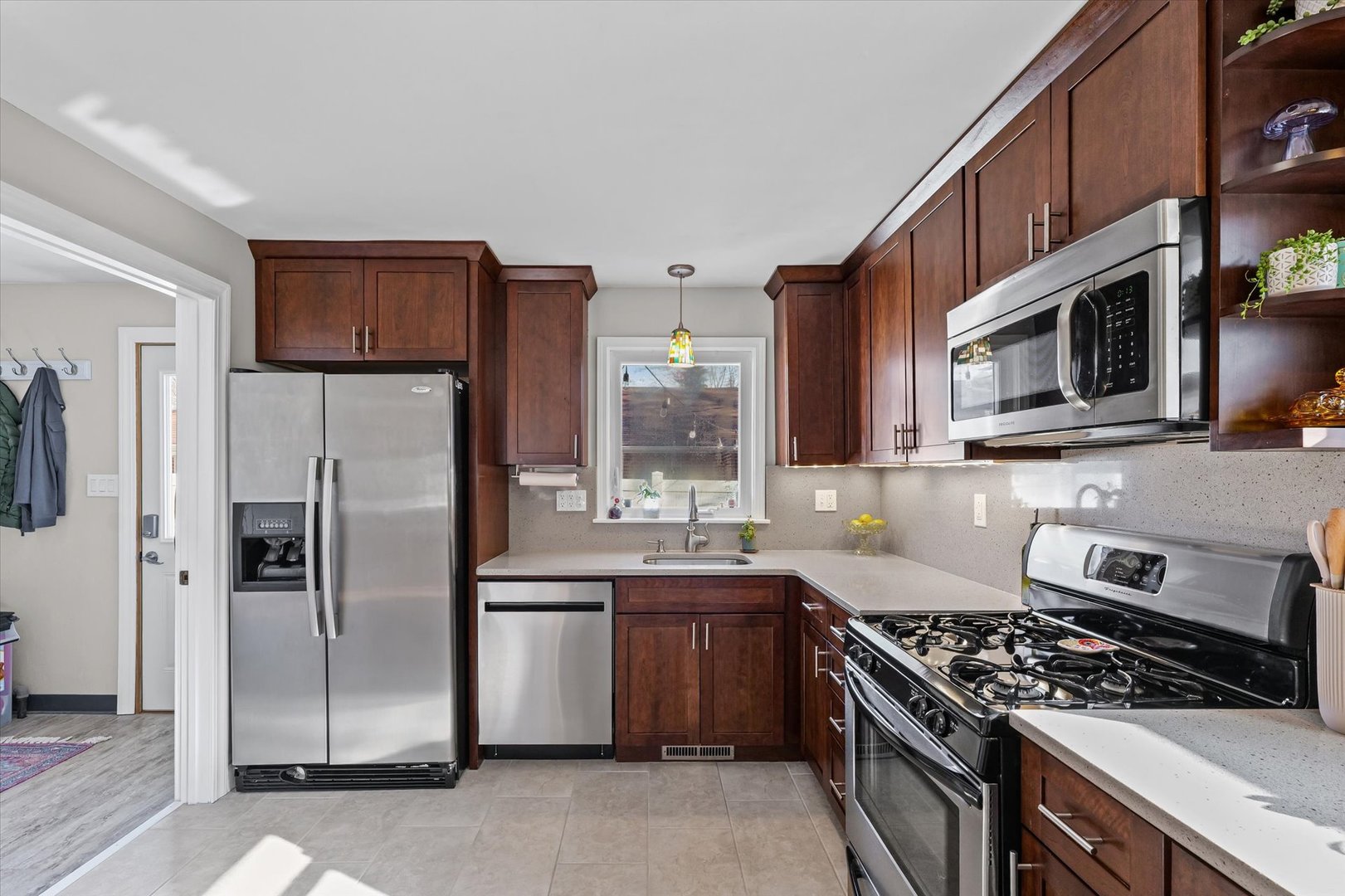 11 Normandy Place Champaign, IL 61821 - Photo 17 of 37 a kitchen with stainless steel appliances granite countertop a stove a refrigerator and a microwave