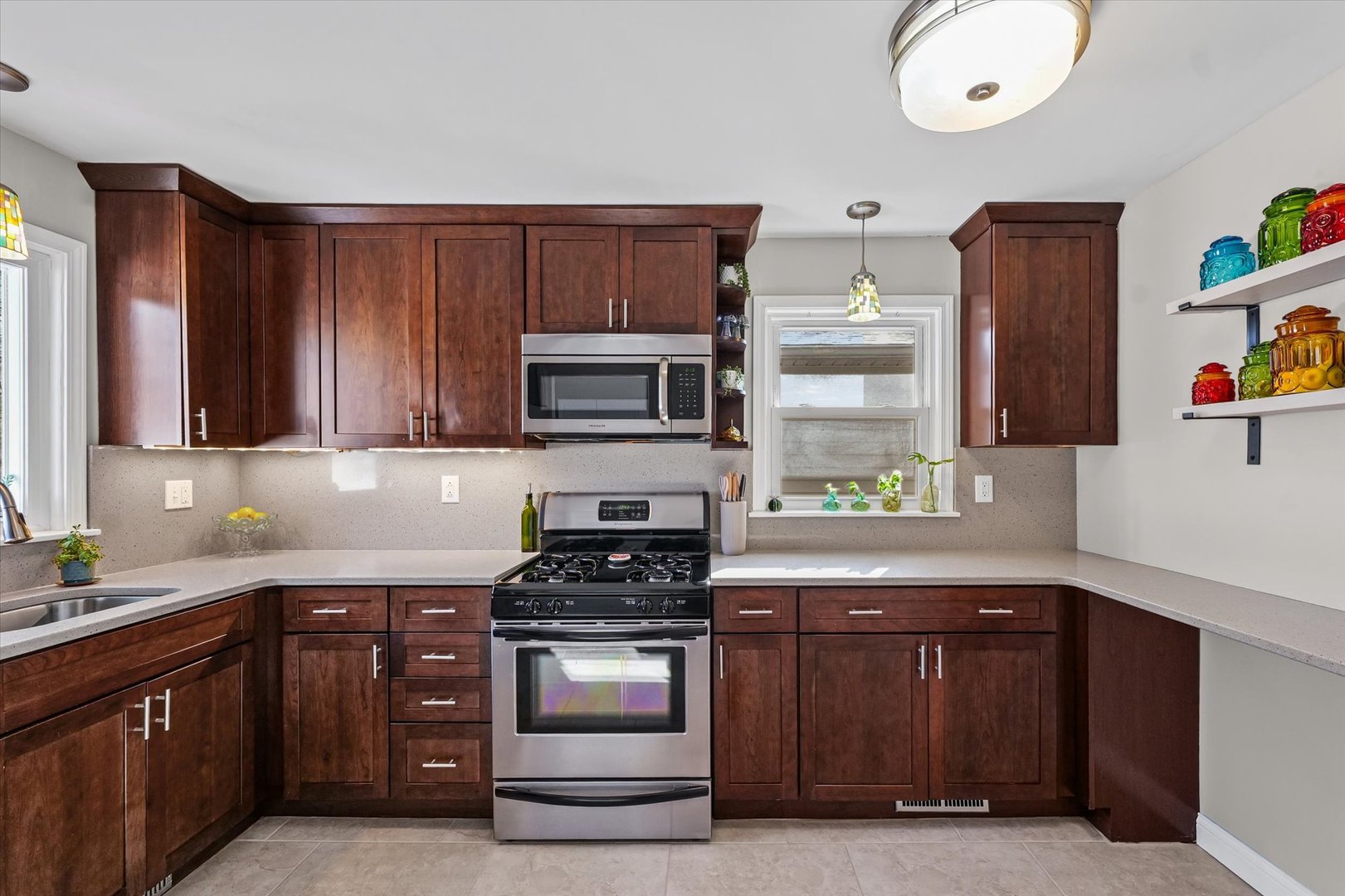11 Normandy Place Champaign, IL 61821 - Photo 20 of 37 a kitchen with stainless steel appliances granite countertop a stove a microwave and wooden cabinets