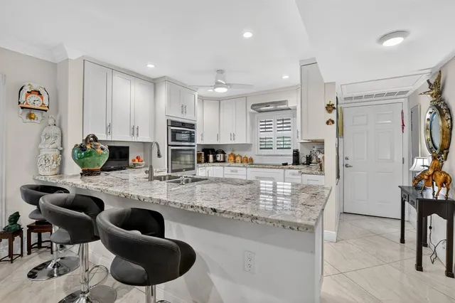 a large kitchen with lots of counter space and furniture