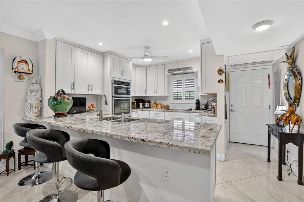 250 Northeast 20th Street, Unit 2270 Boca Raton, FL 33431 - Photo 1 of 39 a large kitchen with lots of counter space and furniture