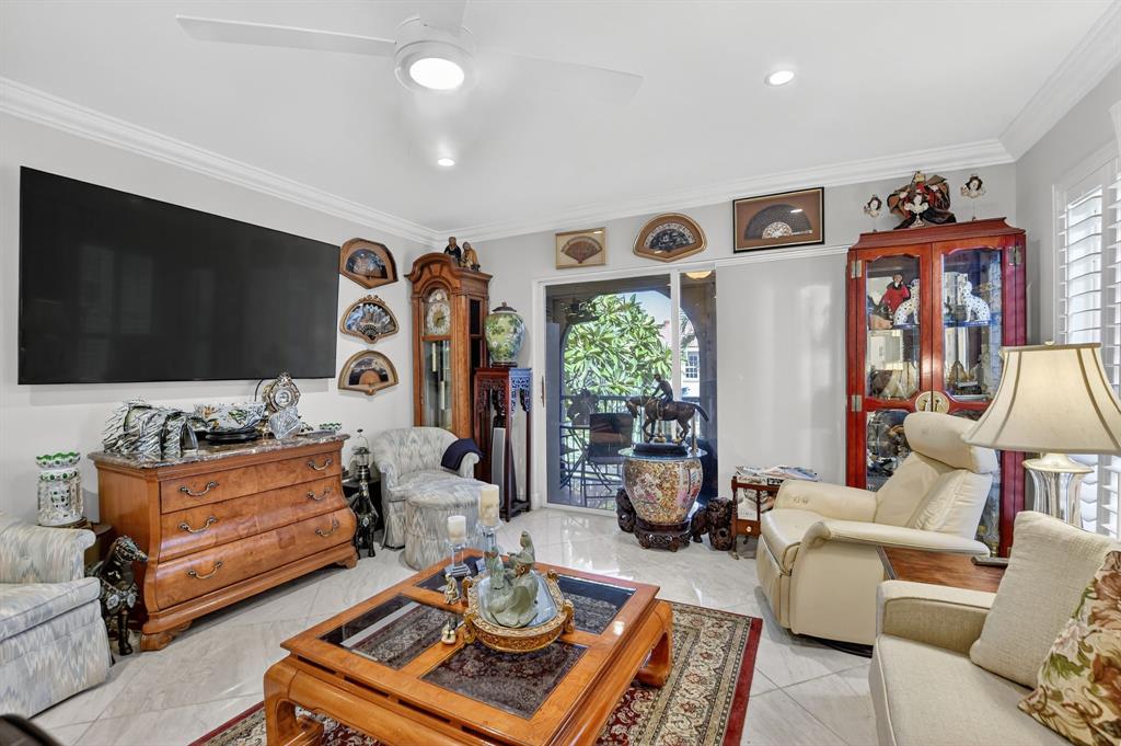 250 Northeast 20th Street, Unit 2270 Boca Raton, FL 33431 - Photo 14 of 39 a living room with furniture and a flat screen tv