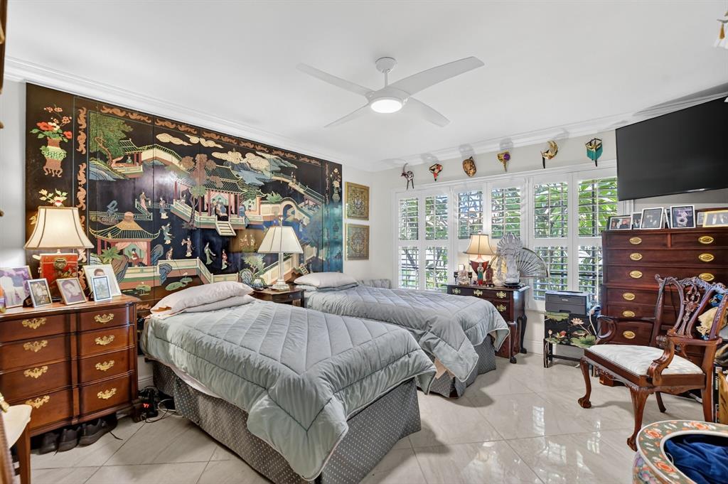 250 Northeast 20th Street, Unit 2270 Boca Raton, FL 33431 - Photo 17 of 39 a bedroom with a bed a flat screen tv and a couch