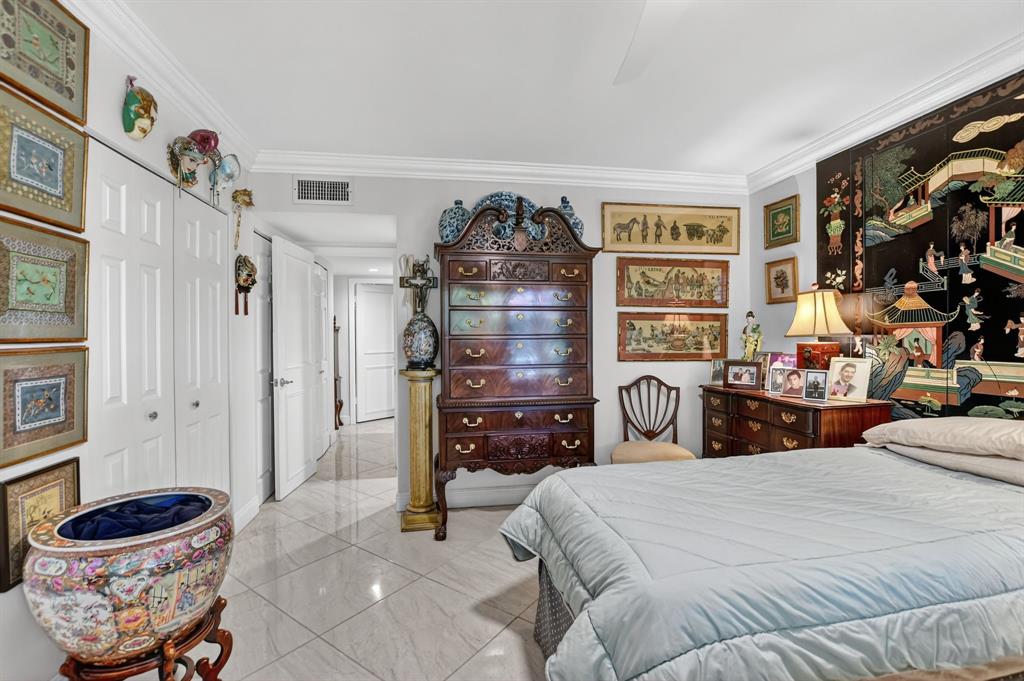 250 Northeast 20th Street, Unit 2270 Boca Raton, FL 33431 - Photo 18 of 39 a bedroom with a bed and walk in closet