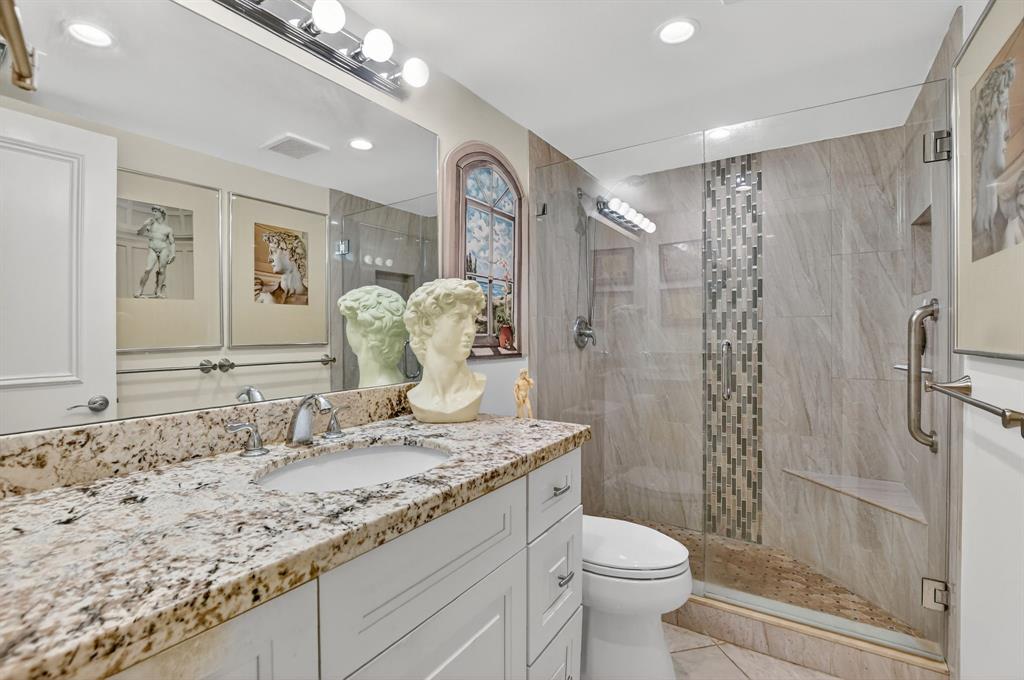 250 Northeast 20th Street, Unit 2270 Boca Raton, FL 33431 - Photo 19 of 39 a bathroom with a granite countertop sink toilet and shower