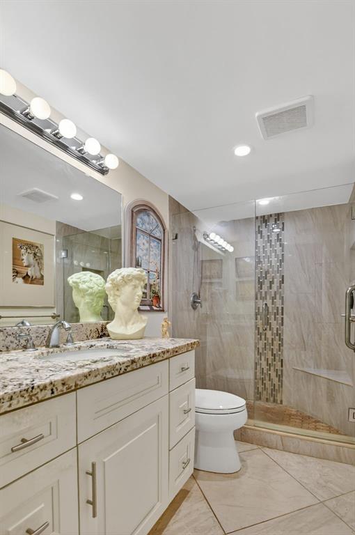 250 Northeast 20th Street, Unit 2270 Boca Raton, FL 33431 - Photo 20 of 39 a bathroom with a granite countertop sink a toilet and shower