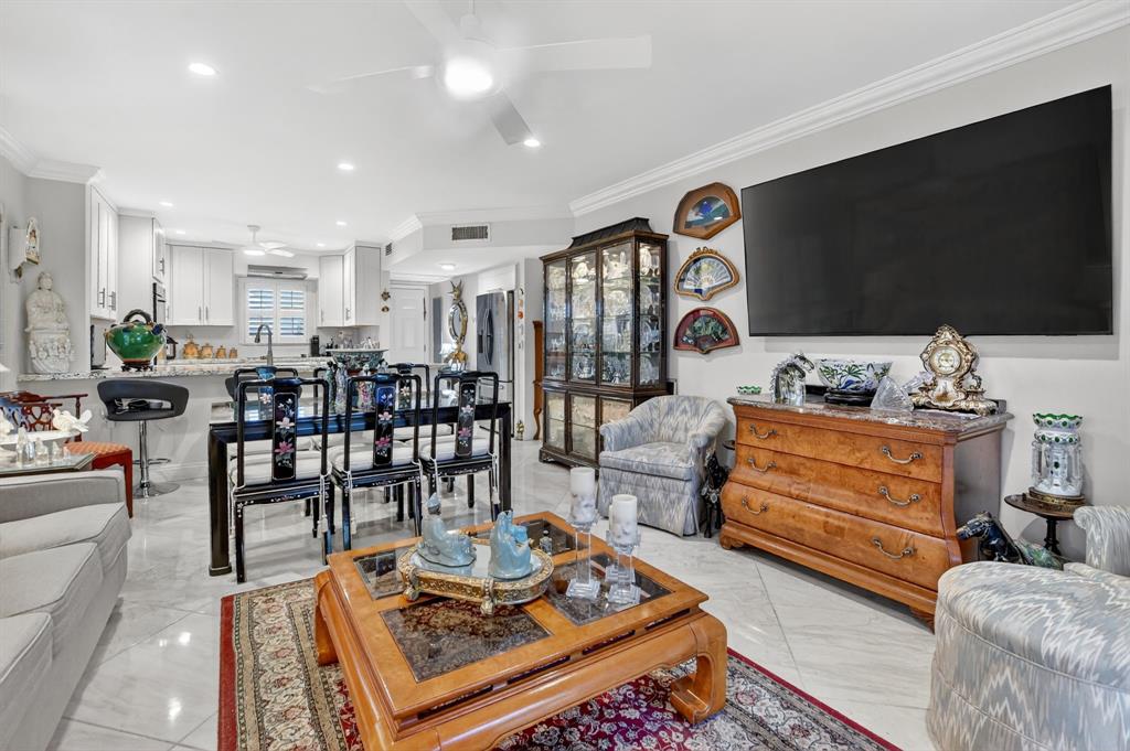 250 Northeast 20th Street, Unit 2270 Boca Raton, FL 33431 - Photo 2 of 39 a living room with furniture and a flat screen tv