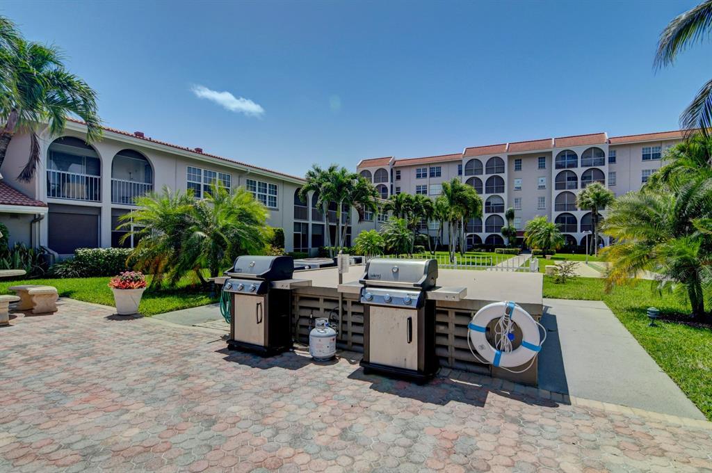 250 Northeast 20th Street, Unit 2270 Boca Raton, FL 33431 - Photo 32 of 39 a view of a patio with couches and table and chairs and potted plants