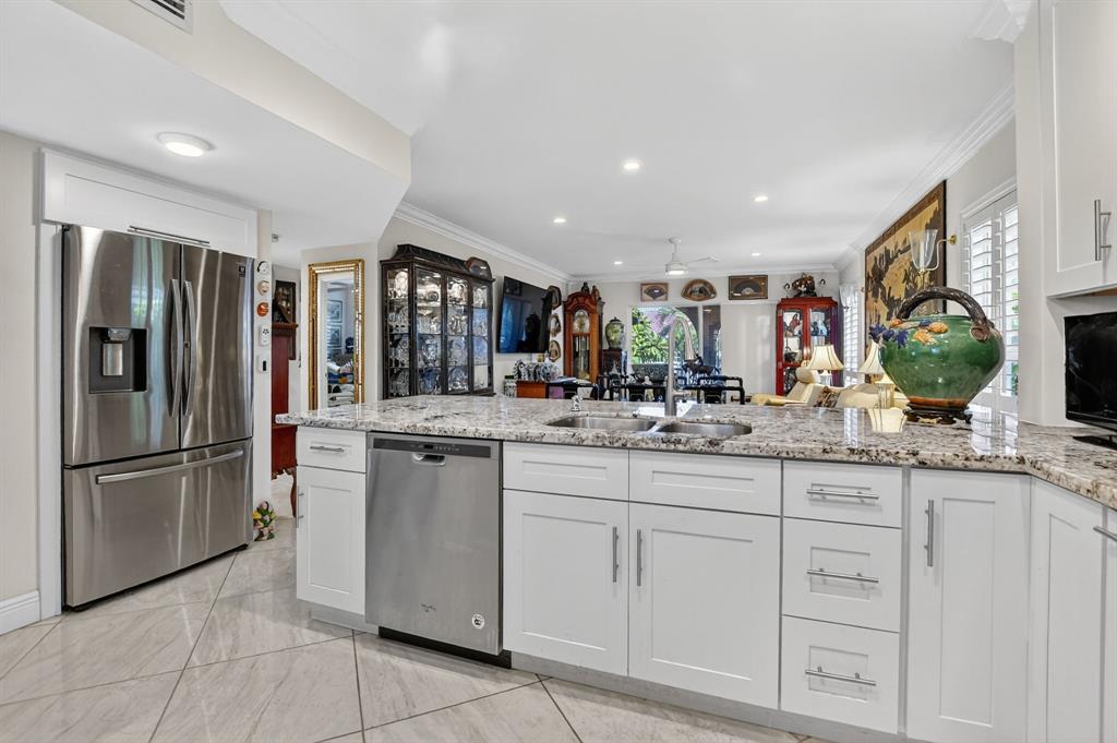 250 Northeast 20th Street, Unit 2270 Boca Raton, FL 33431 - Photo 9 of 39 a kitchen with stainless steel appliances granite countertop a refrigerator and a sink