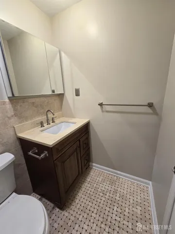 a bathroom with a sink vanity and toilet