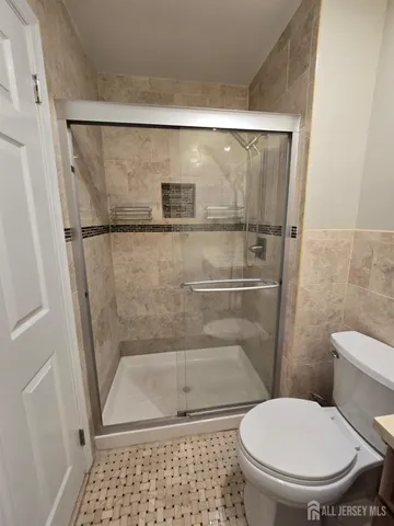 a bathroom with a toilet and a shower