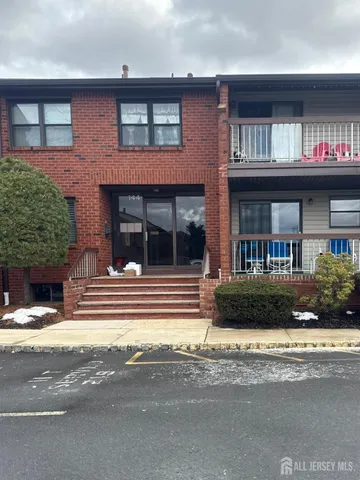 a view of brick building with a small yard