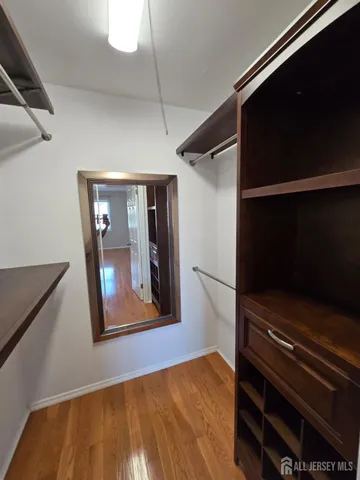 a view of a living room with a wooden floor and a window