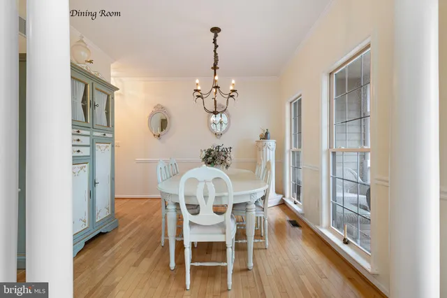 a view of a dining room with furniture wooden floor and chandelier