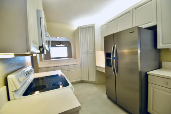 a kitchen with a refrigerator sink and stove