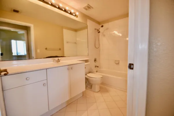 a spacious bathroom with a shower sink and mirror