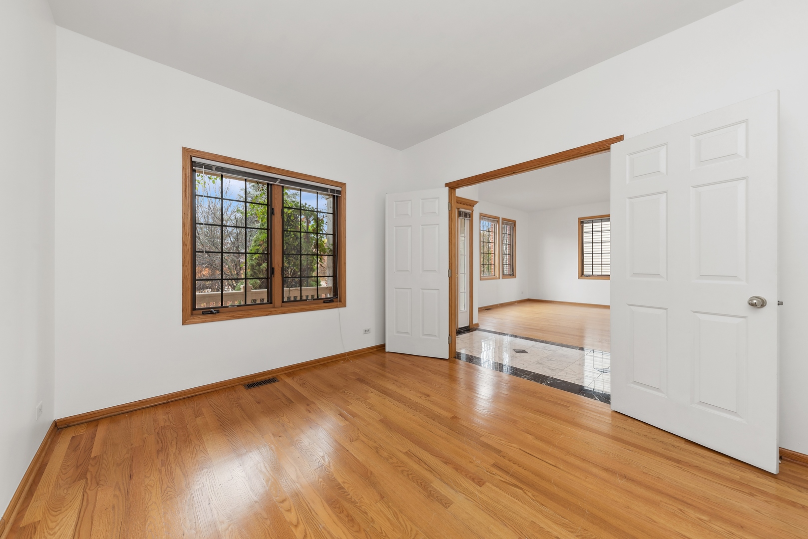 1115 South Elmhurst Road Wheeling, IL 60090 - Photo 14 of 33 a view of empty room with wooden floor and fan