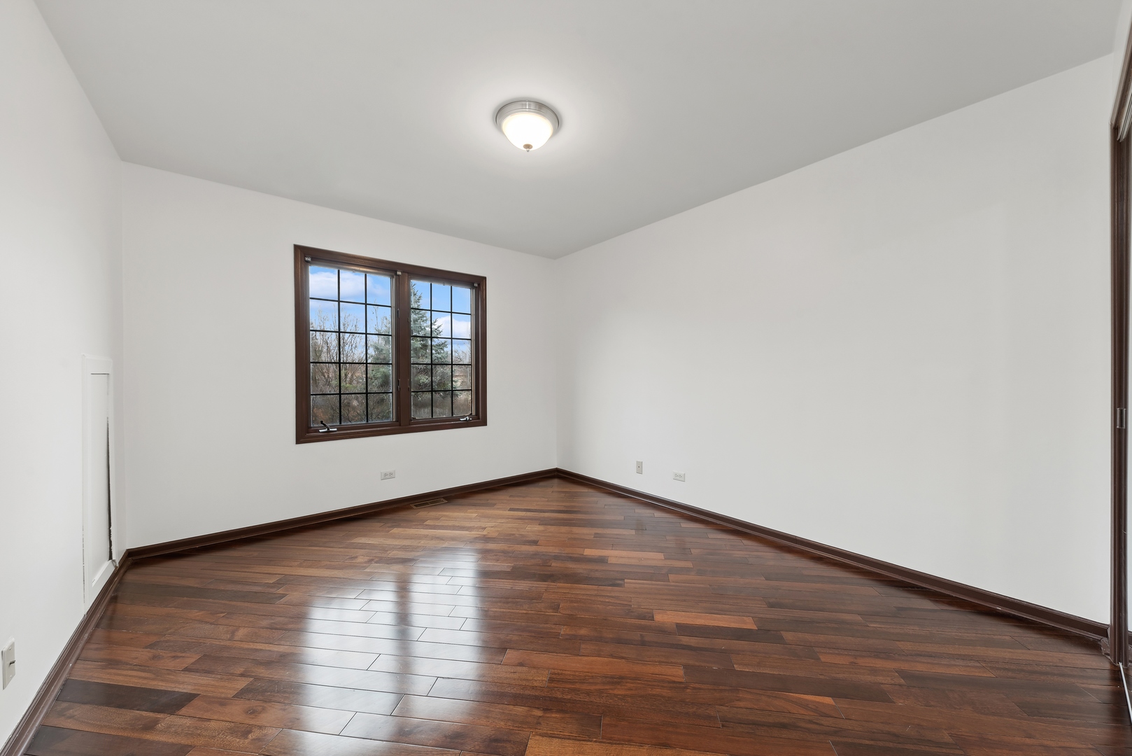1115 South Elmhurst Road Wheeling, IL 60090 - Photo 20 of 33 a view of an empty room with wooden floor and a window