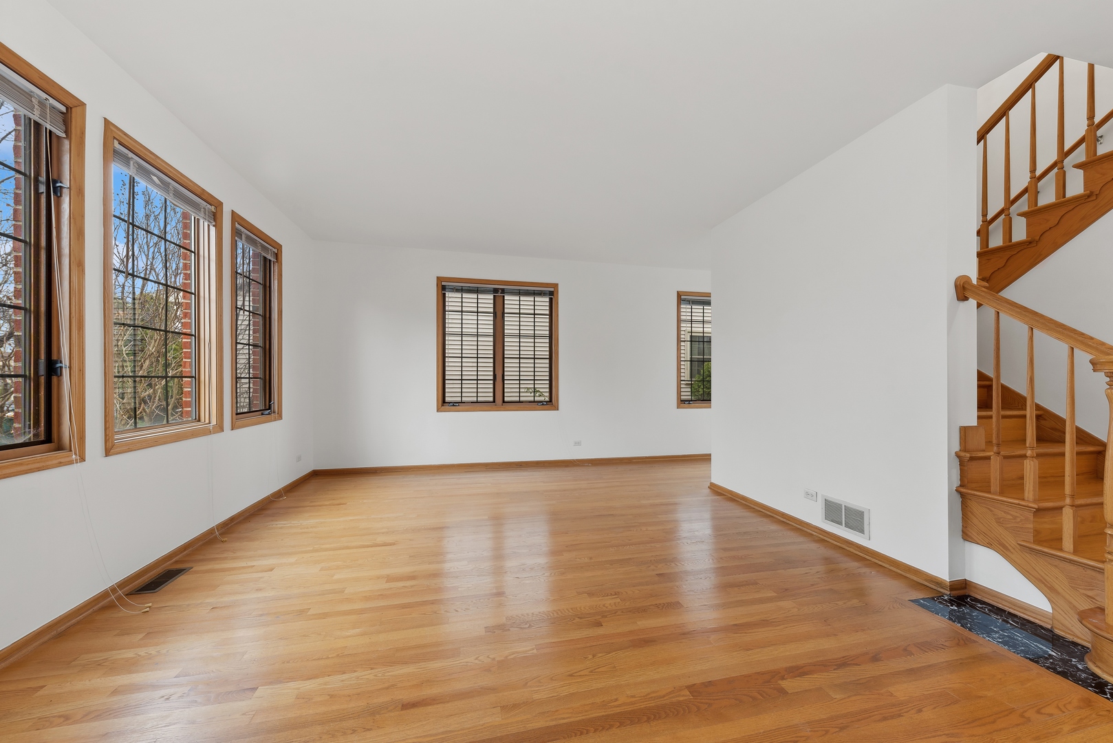 1115 South Elmhurst Road Wheeling, IL 60090 - Photo 2 of 33 a view of an empty room with glass door and wooden floor