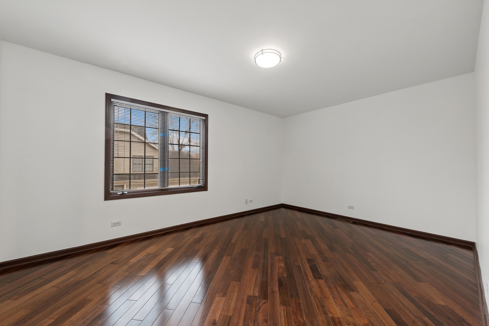 1115 South Elmhurst Road Wheeling, IL 60090 - Photo 21 of 33 an empty room with wooden floor and windows